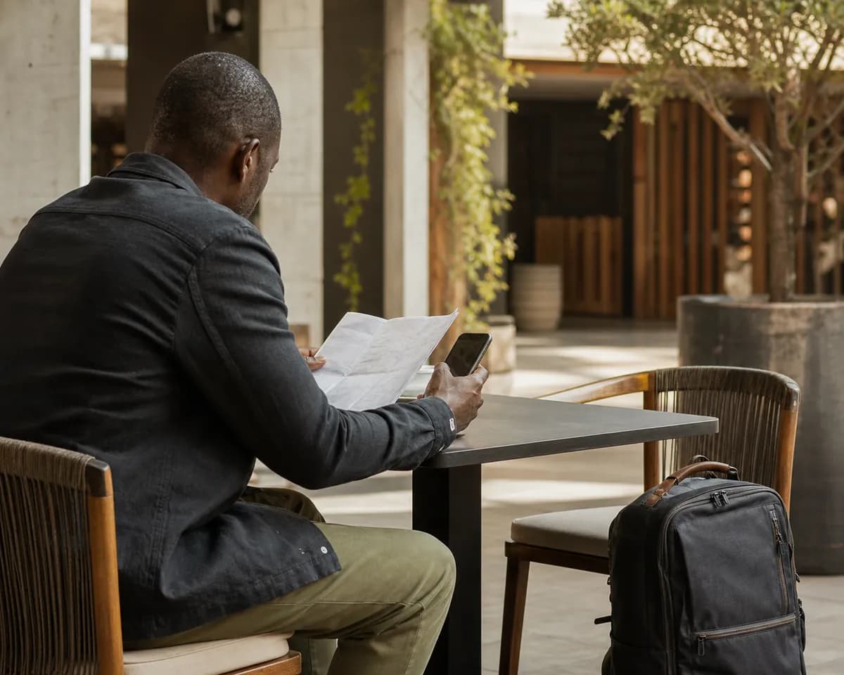 Traveller reviewing journey details at a table.